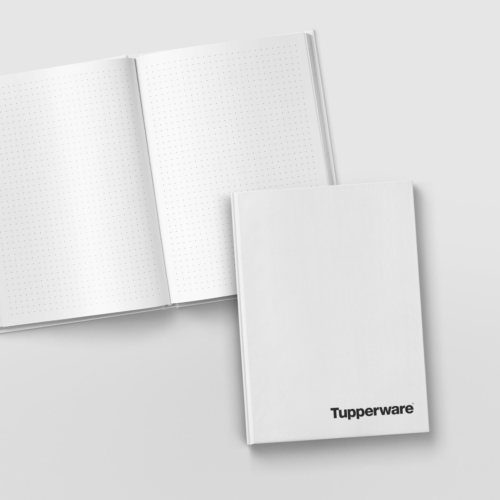 Notizbuch DIN A4 von der Marke Tupperware / Weiß mit gepunkteter Lineatur / mit schwarzer Aufschrift \"Tupperware\" / 64 Seiten / Naturpapier / Hier direkt online kaufen 